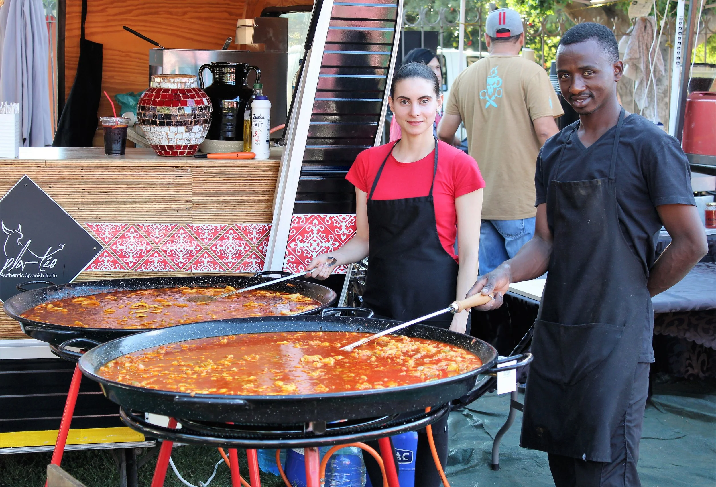 Sarita and team cooking paella at a Pla-téo event